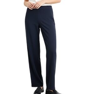 Minimalist dark blue pleated pull on stretchy baggy straight leg trousers